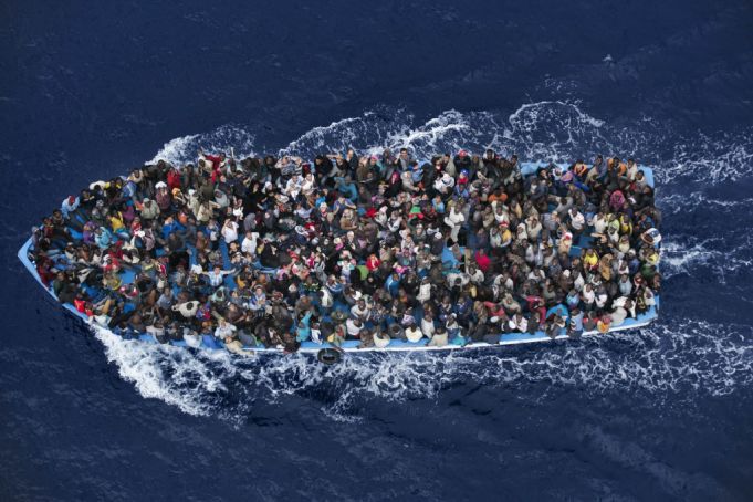 Operation Mare Nostrum. Shipwrecked aboard a boat are rescued 20 miles north from Libya by the frigate FREMM Bergamini of the Italian Navy