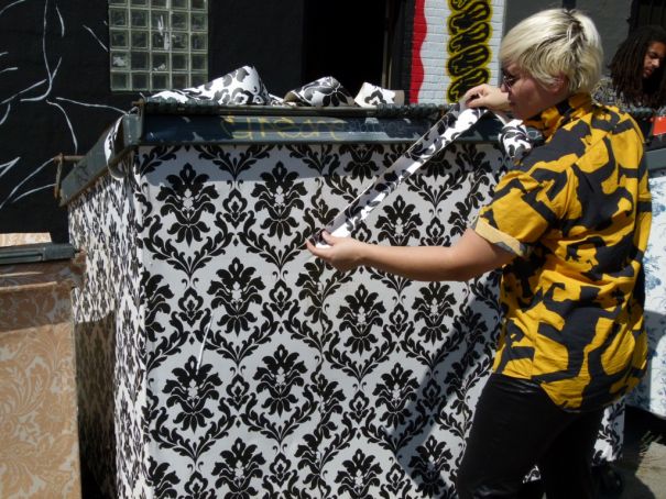 C. Finley and one of her Wallpapered Dumpsters. Photo by Tanja M. Laden.