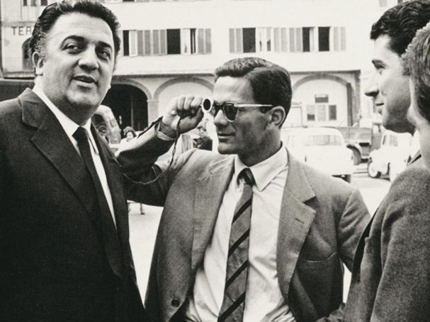 Federico Fellini (left) employed Pasolini as a consultant for his 1957 film Le notti di Cabiria.