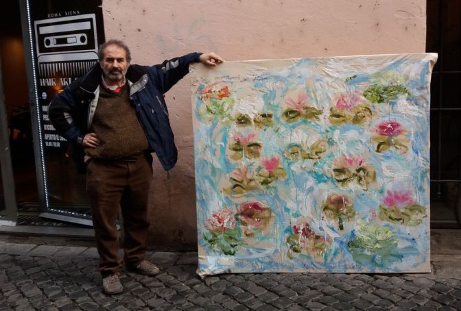 Giancarlino with one of his flower paintings on Via dei Cappellari.