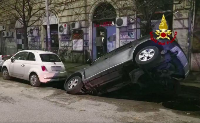 Rome sinkhole swallows two cars