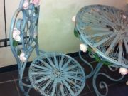Selling round antiqued patio iron table with two c