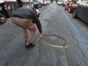 Romans highlight city's potholes with spray paint