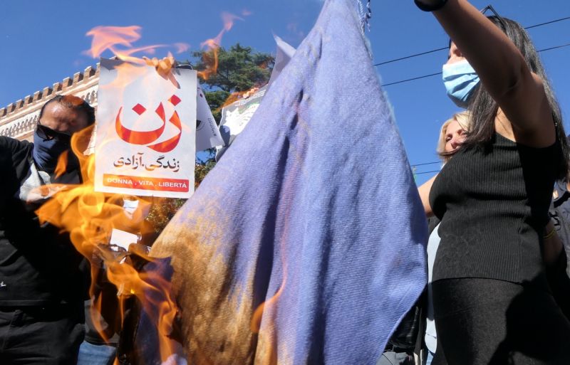 Mahsa Amini: Women cut hair and burn hijabs outside Iran embassy in It